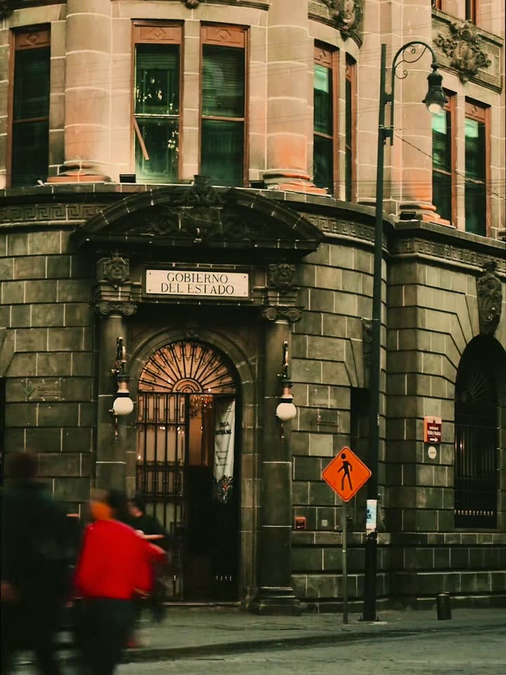 Historic stone building on a busy old-town street